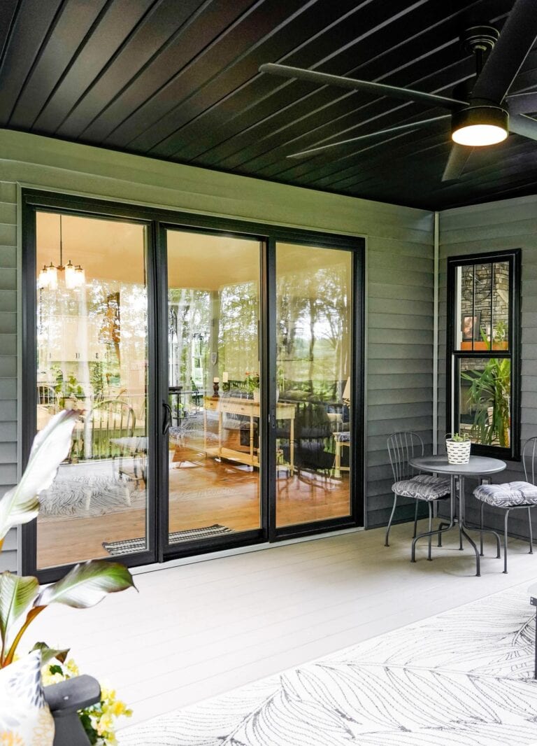 Black ProVia Endure sliding patio door opening to a covered porch